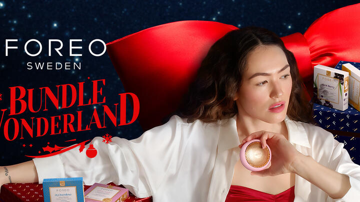 A woman using FOREO devices in a holiday setting